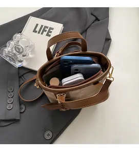 Interior view of beige canvas tote showing capacity for smartphones and lipstick