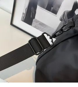 Gros plan sur la bandoulière réglable en nylon avec crochet rotatif en métal noir du sac
