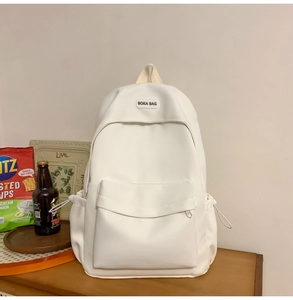Detail of off-white casual backpack featuring large front pocket and side drawstring pouch