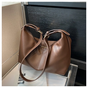 Close-up of dark brown pebbled leather hobo bag with gold hardware and zipper detail