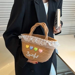 Handcrafted woven straw tote bag with lace trim and colorful heart charms for women