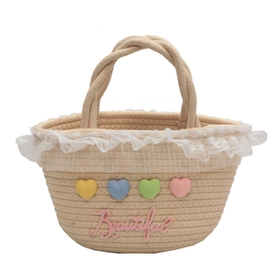 Handmade beige woven straw handbag with colorful hearts and lace trim in a 45-degree view