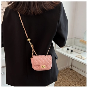 Detailed view of pink quilted mini bag with gold chain strap and metal turn lock clasp