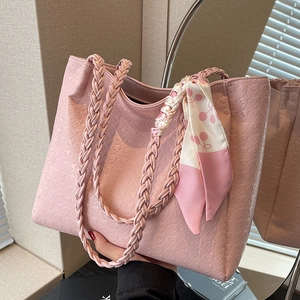 Pink embossed tote bag with woven handles and silk scarf detail for elegant daily use