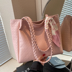 Pink houndstooth embossed tote bag with woven handles and cherry pattern scarf decoration