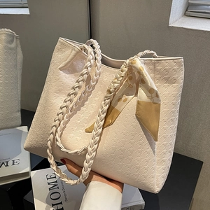 Chic beige houndstooth tote bag with woven straps and decorative floral silk scarf