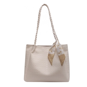 Elegant beige tote bag with woven straps and decorative scarf for daily office commuting