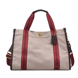 Large grey canvas tote bag with brown leather trim and striped straps for women