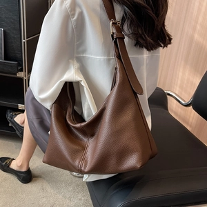 Deep brown pebble leather hobo bag with adjustable wide strap and gold hardware
