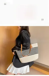 Detailed view of striped woven tote bag with brown leather handles worn by a model