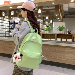 Minimalist light green nylon backpack with cute puppy pendant for school and travel