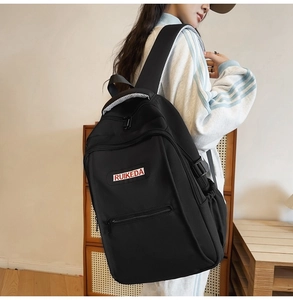 Side view of black large-capacity backpack showing front pocket and buckle details