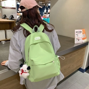 Light green nylon backpack with cute puppy pendant and BOKA BAG label for travel