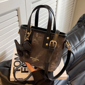 Mini tote bag in textured charcoal grey with black leather handles and dog charm accessory