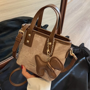 Canvas bucket bag with brown leather trim and cute dog charm pendant accessory