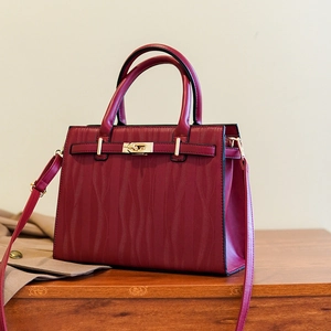 Elegant wine red handbag with wave-embossed texture and gold lock for women