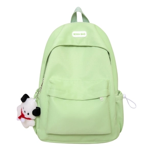 Minimalist mint green travel backpack for women with front pocket and plush charm