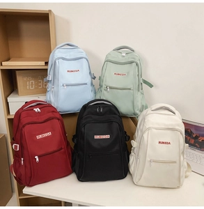 Detailed shot of multi-color nylon backpacks in blue, green, red, black, and beige