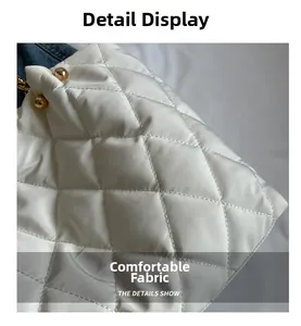 Detail of white quilted nylon tote featuring gold sphere clasps and plush diamond pattern
