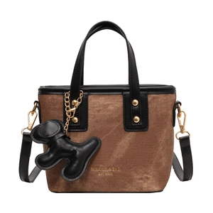 Brown denim and black leather bucket bag with dog charm and gold logo detail