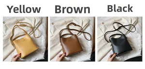 Detailed view of leather bucket bags in yellow, brown and black with adjustable straps