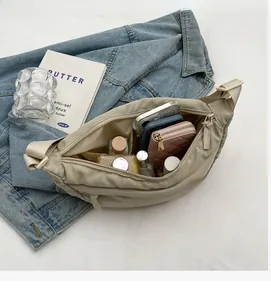 Interior view of the beige nylon crossbody bag showing large capacity and internal pockets