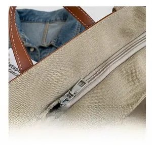 Detailed shot of smooth metal zipper and premium stitching on canvas tote bag