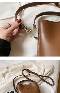 Detailed view of dark brown bucket bag with gold hardware and litchi texture
