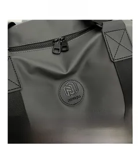 Detail showing waterproof Oxford fabric texture and metal zipper on large travel bag