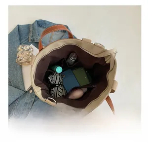 Detail view of large capacity canvas tote with multiple pockets and interior storage