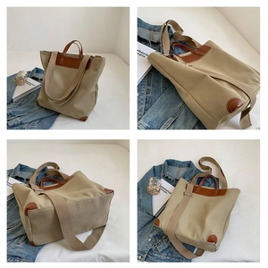 Detail view of khaki canvas tote with brown leather trim and multi-way shoulder straps