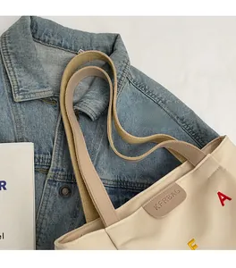 Detailed shot of comfortable dual straps and colorful embroidery on canvas tote bag