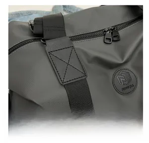 Detail showing high-quality cross-stitching and waterproof oxford fabric on grey travel bag
