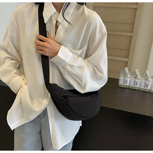 Crossbody black nylon crescent bag on model showing large capacity for daily use