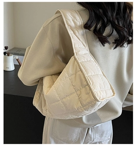 Close-up of cream quilted tote bag showing premium diamond stitching and soft texture