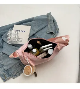 Interior view showing large capacity and compartments of pink nylon crossbody bag