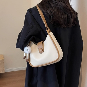 Minimalist cream and brown contrast shoulder bag with cute white plush monster charm