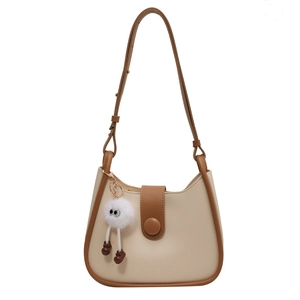 Minimalist cream and brown bucket bag with creative long-legged plush charm and shoulder strap