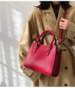 Detail of red wedding handbag with gold lettering on elegant lychee textured leather