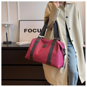 Close-up of pink Oxford travel bag showing large capacity and reinforced black handles