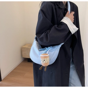 Light blue nylon hobo bag with wide strap and cute coffee cup plush charm detail