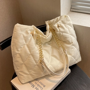 Chic cream white quilted nylon tote bag with golden chain straps and soft puffer design