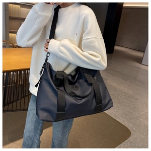 Large navy blue waterproof oxford travel bag shown with a shoulder strap for gym and fitness