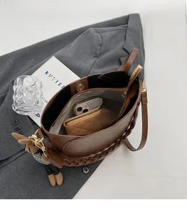 Top view of brown leather bucket bag showing large interior capacity and zipper pocket