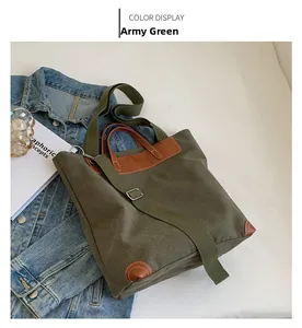 Close-up of army green canvas tote with brown leather trim and adjustable strap