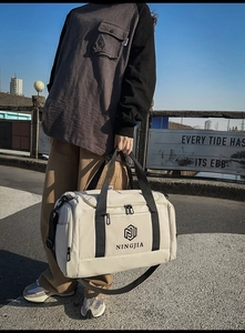 Detail of high-capacity nylon travel bag with Ningjia logo and durable webbing handles