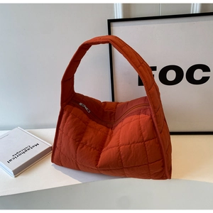 Fashionable orange quilted canvas handbag with durable zipper and minimalist tote design