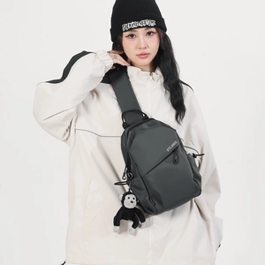 Large dark grey nylon crossbody bag with STLANGS logo and plush monkey charm accessory