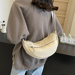 Versatile beige crescent nylon tote bag with adjustable strap for women in a stylish look