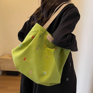 Lime green canvas tote bag with colorful embroidery and leather shoulder straps for women